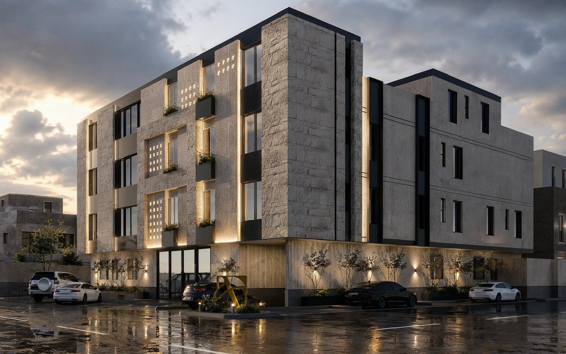 Alurean Two — a dusk view of the stone corner residential mass under a dramatic sky, wet forecourt